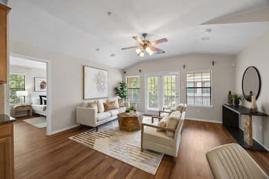 Living area featuring dark wood-type flooring, ce