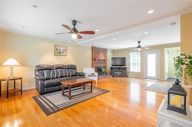 Great room with Raised Hearth fireplace and wood f