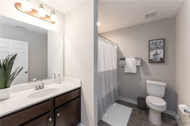 Bathroom featuring tile patterned flooring, vanity