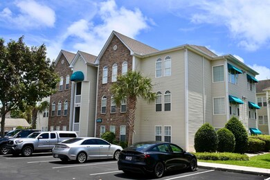 View of property with uncovered parking