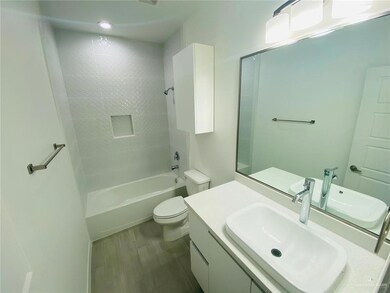 Full bathroom featuring toilet, vanity, bathing tub / shower combination, and wood finished floors