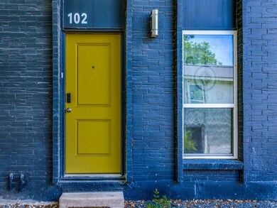 Entrance to property featuring brick siding