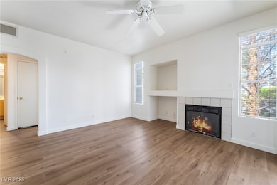Unfurnished living room featuring arched walkways,