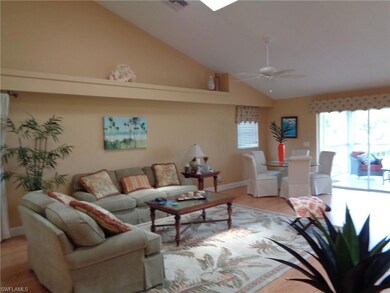 Living room featuring lofted ceiling, ceiling fan,