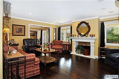 LIVING ROOM WITH FIREPLACE AND WOOD FLOORS