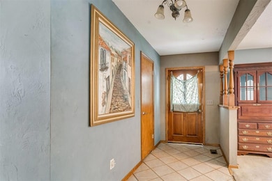 Foyer featuring baseboards and light tile patterned flooring