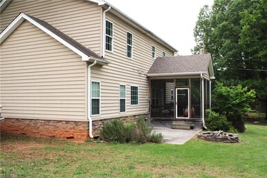 Back of house, fire pit & screened in porch