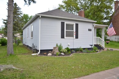 View of side of property featuring a yard
