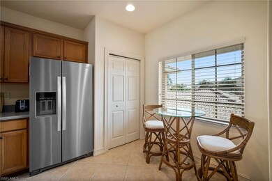 Kitchen with stainless steel fridge and light tile
