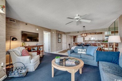 Carpeted living area with a textured ceiling, ceil