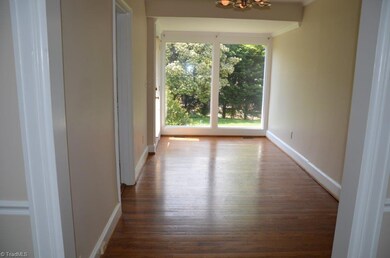Nice flow for living and entertaining, with large picture windows for private views from the dining area. Kitchen is through door on left.