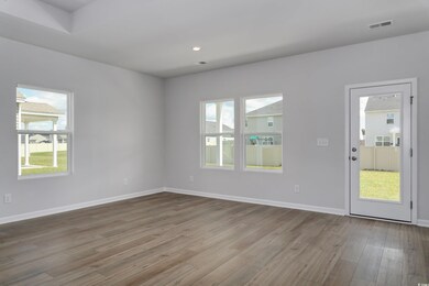 Empty room with hardwood / wood-style flooring and