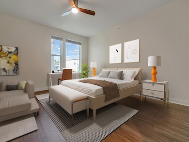 Bedroom featuring wood finished floors, baseboard