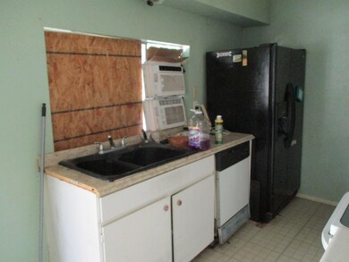 Kitchen featuring white cabinetry, white dishwashe