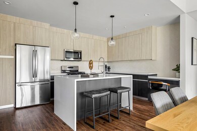 Kitchen with stainless steel appliances, light br