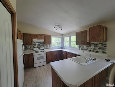 Furnished Refrigerator/Freezer, Stove/Oven, Dishwasher, Pantry Closet, Some cabinets designed to swing out for canned goods.