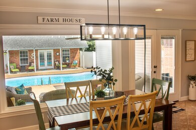 Newly-installed large picture window overlooks the lovely pool, backyard, and guest house. New lighting fixtures throughout the house.