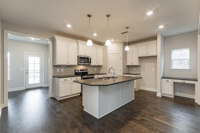 Desk in the kitchen is a nice feature!  Similar home.