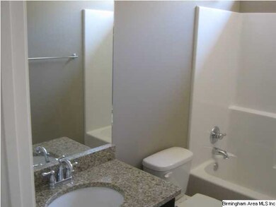 Guest Bath with granite counter top, tile flooring