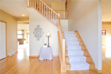 Grand two story foyer with beautiful hardwood floo