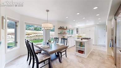 Dining room with healthy amount of natural light, recessed lighting, baseboards, and a chandelier