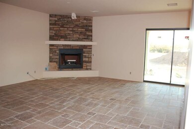 Great room w/ stone floors and fireplace
