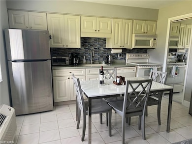 Kitchen featuring light tile patterned flooring, w