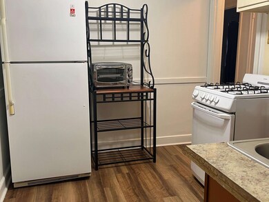 Kitchen featuring white appliances and dark wood-t