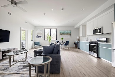Living room with light wood-style floors, baseboa