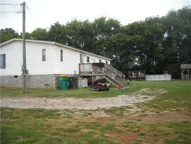 Back of the home with a large deck