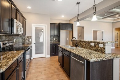 Kitchen with stainless steel appliances, a sink, l