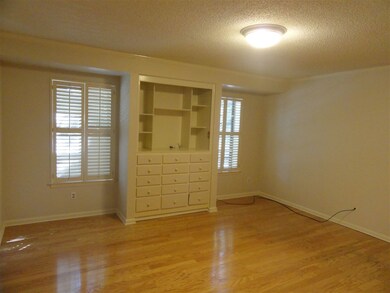 The master bedroom has built-in cabinets and a wal