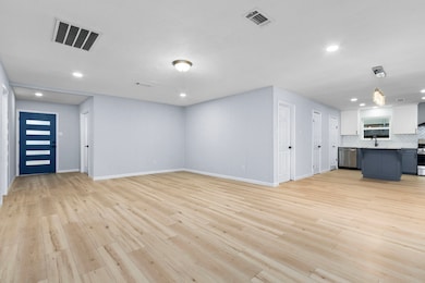 The light luxury vinyl plank flooring brightens th