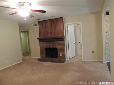 Family room with a wood burning fireplace.