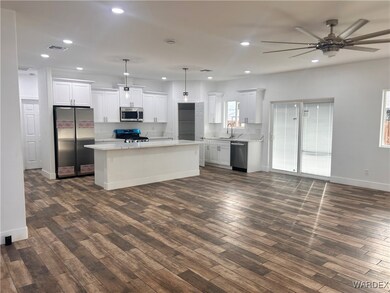 Kitchen featuring a center island, white cabinets,