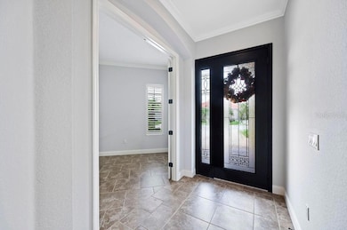 The front entry features a wide 8' tall door and sidelight with decorative leaded glass inserts.
