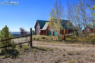 View of side of property with metal roof, fence, and log veneer siding