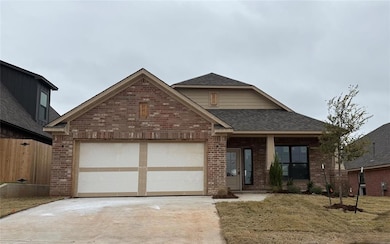 View of front of home featuring brick siding, roof with shingles, driveway, an attached garage, and covered porch
