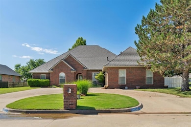 Traditional-style home featuring brick siding and a tiled roof
