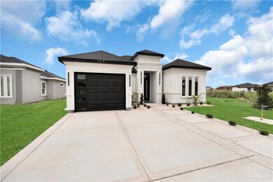 View of front of house featuring driveway, a garage, a front yard, and roof with shingles
