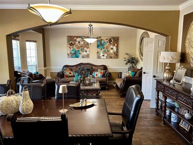 Dining area with dark wood-style floors, arched wa