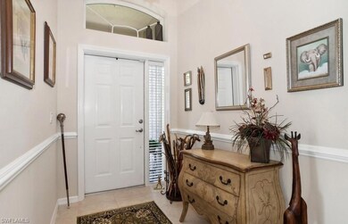 Foyer entrance featuring light tile patterned floo