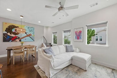 Living room with visible vents, recessed lighting