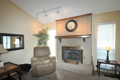 Floor to ceiling fireplace with mantel & two pictu