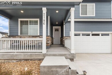 Doorway to property with a garage, covered porch, 