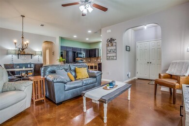 Living room featuring arched walkways, a ceiling 