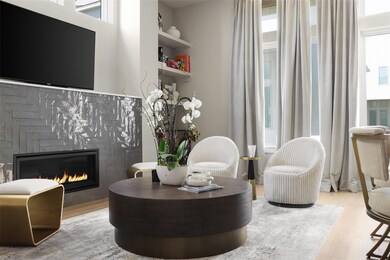 Sitting room featuring a glass covered fireplace,