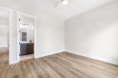 Empty room featuring sink, ceiling fan, and light 