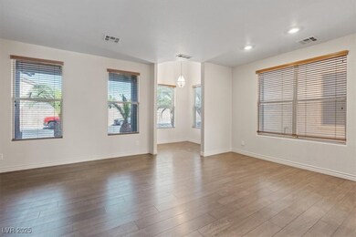 Spare room featuring wood finished floors, baseboa