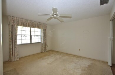 Guest room with amply sized closet and ceiling fan